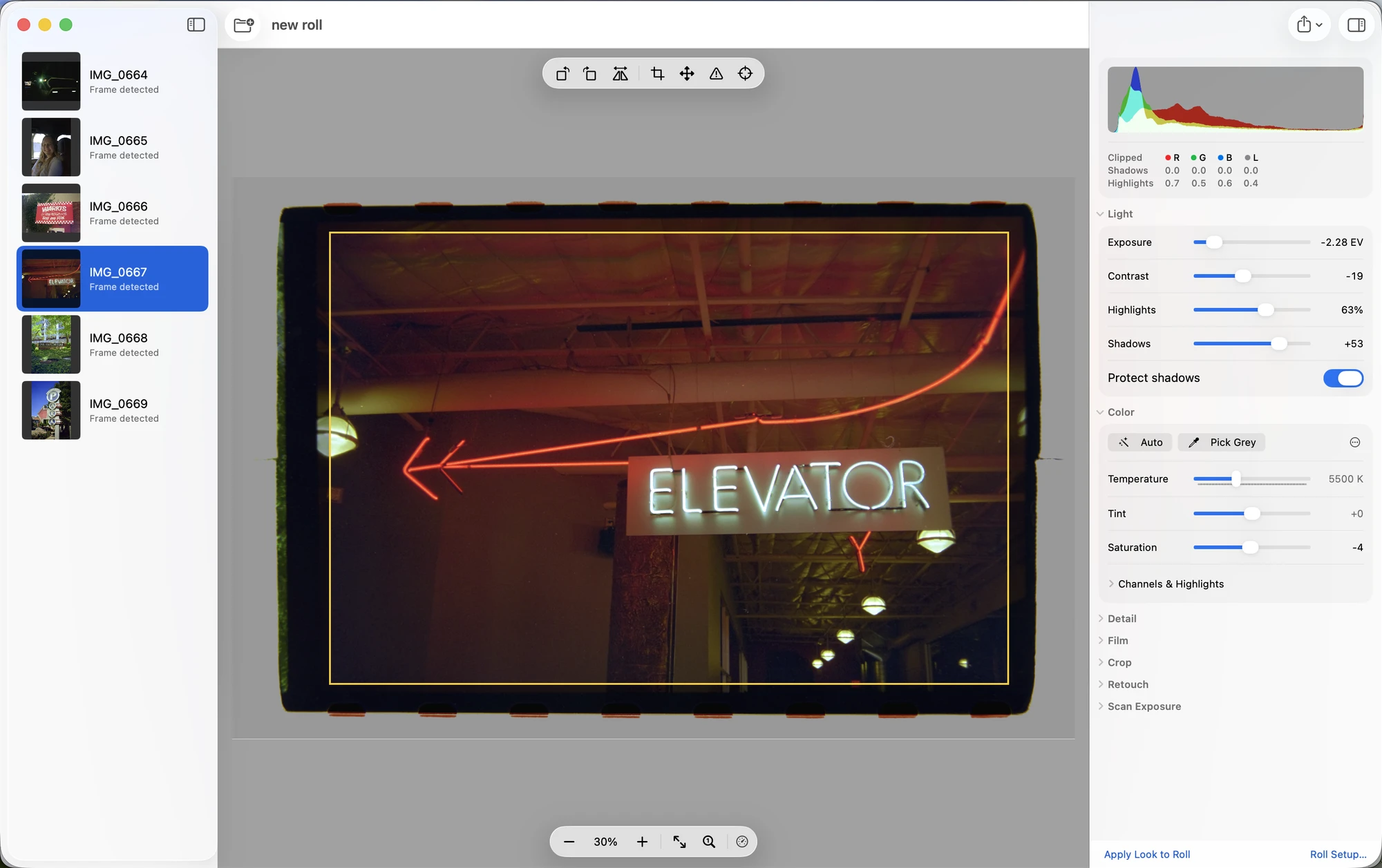 The Invera Lab window: a roll of six scans on the left, the frame with its detected crop in the middle, and exposure, contrast and color controls on the right.